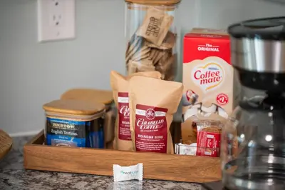 a wooden tray with various food items on a counter at 2BR Condo Near Ark for 6 Guests - Free Parking in Williamstown