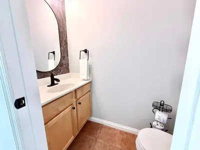 a bathroom with a sink and a mirror at 2BR Condo Near Ark for 6 Guests - Free Parking in Williamstown