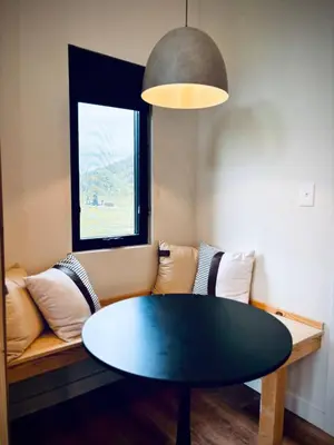 a living room with a table and a couch at Hiker's Haven at Three Suns Cabins in Stanton