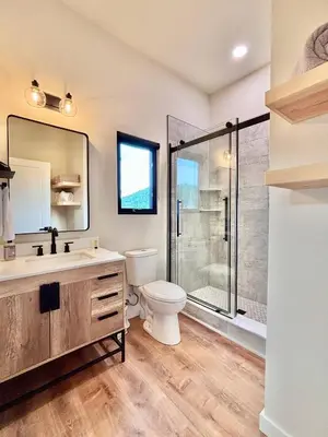 a bathroom with a toilet sink and a shower at Hiker's Haven at Three Suns Cabins in Stanton
