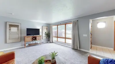 a living room with a tv and a couch at The Halftime Highlight-Big Plays, Comfy Stays in Canton