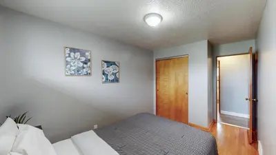 a bedroom with a bed and a wooden door at The Halftime Highlight-Big Plays, Comfy Stays in Canton