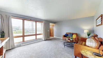 a living room with a couch and a large window at The Halftime Highlight-Big Plays, Comfy Stays in Canton