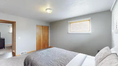 a bedroom with a bed and a window at The Halftime Highlight-Big Plays, Comfy Stays in Canton