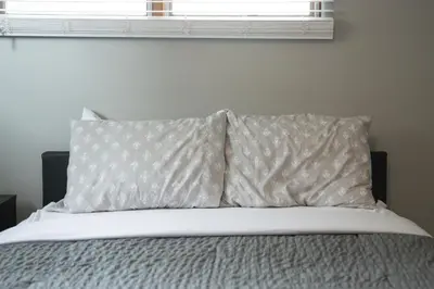 a bedroom with a bed with two pillows and a window at The Halftime Highlight-Big Plays, Comfy Stays in Canton