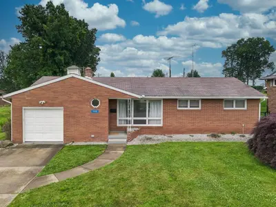a brick house with a white garage at The Halftime Highlight-Big Plays, Comfy Stays in Canton