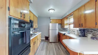 a kitchen with wooden cabinets and a stainless steel appliance at The Halftime Highlight-Big Plays, Comfy Stays in Canton