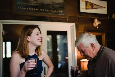 a man and a woman holding a glass of drink at Getaway Inn at Cooper's Woods in Put-in-Bay