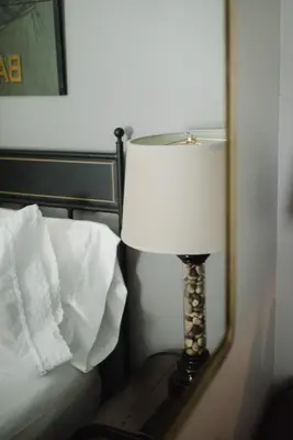 a lamp sitting on a table in front of a mirror at Getaway Inn at Cooper's Woods in Put-in-Bay