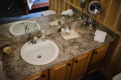 a bathroom counter with a sink and a mirror at Getaway Inn at Cooper's Woods in Put-in-Bay