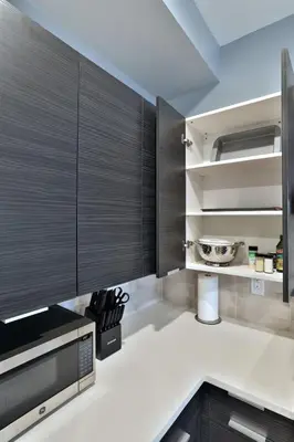 a kitchen with black cabinets and a counter top at The Buckeye's Gem Near Downtown & OSU in Columbus