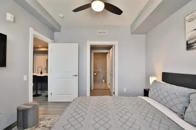 a bedroom with a bed and a ceiling fan at The Buckeye's Gem Near Downtown & OSU in Columbus