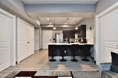 a kitchen with a large island in the middle of a room at The Buckeye's Gem Near Downtown & OSU in Columbus