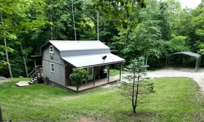 a tiny house in the middle of a yard at Secluded Cabin Rental, Perfect for an Ohio Retreat in Scio