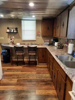 a kitchen with two chairs and a counter with a sink at Secluded Cabin Rental, Perfect for an Ohio Retreat in Scio