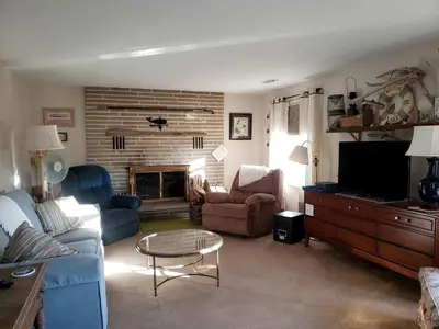a living room with a couch and chairs and a tv at Idyllic Beachfront Vacation Rental on the Shores of Lake Erie in Northern Ohio in Vermilion