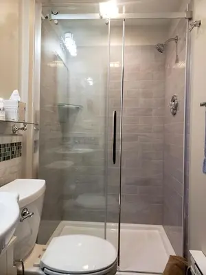 a bathroom with a shower with a toilet and a sink at Idyllic Beachfront Vacation Rental on the Shores of Lake Erie in Northern Ohio in Vermilion