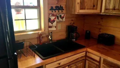 a kitchen with a sink and a counter top at Authentic Stunning Cabin Rental with Private Jacuzzi near Huntington, West Virginia in Genoa