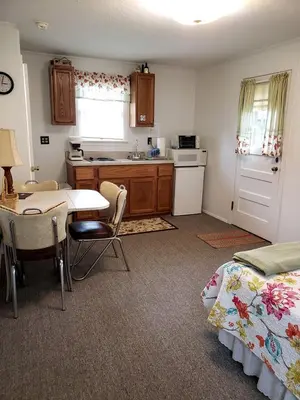 a kitchen with a table and a kitchen with a dining room at Rustic Lakeside Vacation Rental with Beach Access in Vermilion, Ohio in Vermilion