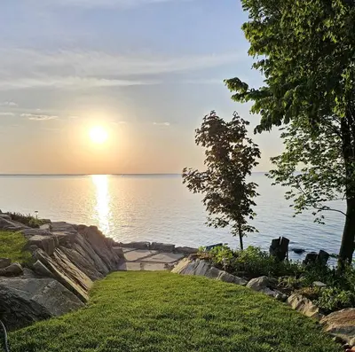 a view of the sun setting over the water at Charming Beach Cottage Along Lake Erie near Cleveland, Ohio in Vermilion