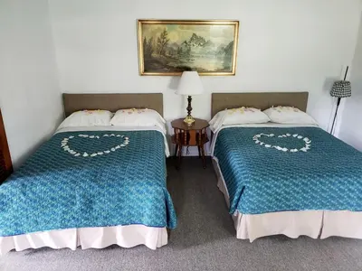 two beds sitting next to each other in a room at Charming Beach Cottage Along Lake Erie near Cleveland, Ohio in Vermilion