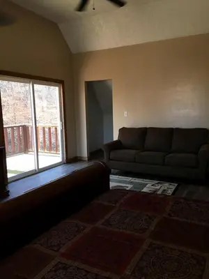 a living room with a couch and a window at Stunning Getaway Cabin with Expansive Decks near Huntington, West Virginia in Genoa