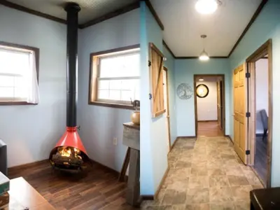 a hallway with a woodburning stove in a house at Rustic Cabin in the Countryside near Muskingum River State Park, Ohio in McConnelsville