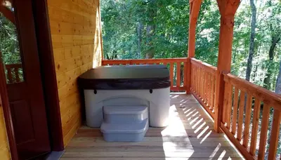 a toilet sitting on the porch of a cabin at Rustic Family-Friendly Accommodation with Jacuzzi near Huntington, West Virginia in Genoa