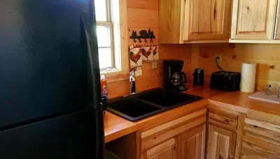 a kitchen with a sink and a counter top at Rustic Family-Friendly Accommodation with Jacuzzi near Huntington, West Virginia in Genoa