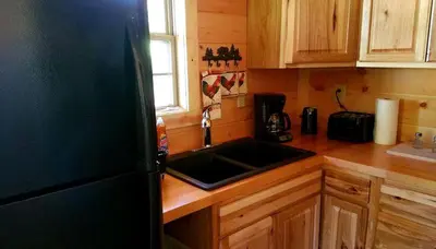 a kitchen with a sink and a counter top at Rustic Family-Friendly Accommodation with Jacuzzi near Huntington, West Virginia in Genoa