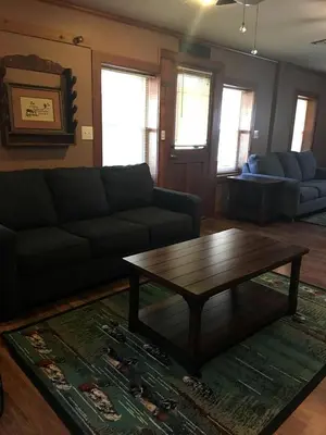 a living room with a couch and a coffee table at Gorgeous Vacation Cabin for Groups with Stylish Interior near Huntington, West Virginia in Genoa