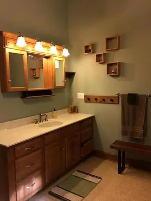 a bathroom with a sink and a mirror at Gorgeous Vacation Cabin for Groups with Stylish Interior near Huntington, West Virginia in Genoa
