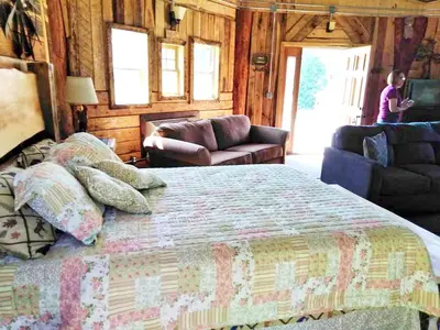 a bedroom with a bed and a woman in a room at Unique Rustic Yurt Rental for a Peaceful Retreat near Huntington, West Virginia in Genoa