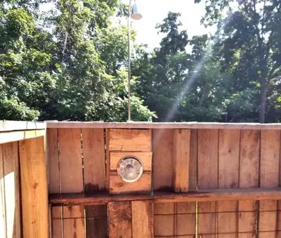 a wooden fence with a clock on top of it at Unique Rustic Yurt Rental for a Peaceful Retreat near Huntington, West Virginia in Genoa
