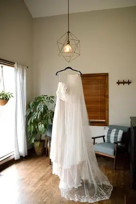a wedding dress hanging in a living room at Stunning Home Away From Home in New Albany, Ohio, For Restful Escapes to Nature in New Albany