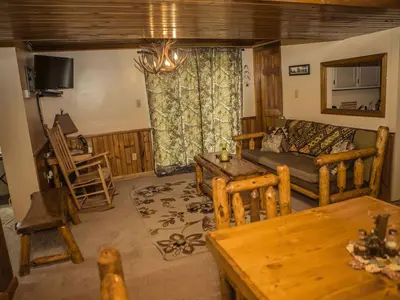 a living room with a couch and a table at Magnificent A-Frame Cabin Rental in the Trees close to Hocking Hills State Park, Ohio in Laurelville