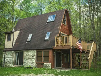 a house with a clock on the top of it at Magnificent A-Frame Cabin Rental in the Trees close to Hocking Hills State Park, Ohio in Laurelville
