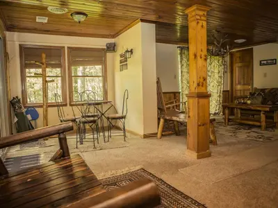 a living room with a table and a dining room at Magnificent A-Frame Cabin Rental in the Trees close to Hocking Hills State Park, Ohio in Laurelville