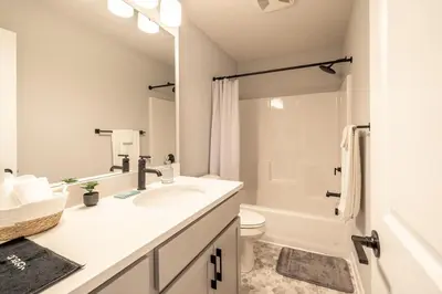a white bathroom with a sink and a toilet at Arcade Game Room! Luxury New 3BR CLE Clinic UnivCircle Little Italy in Cleveland