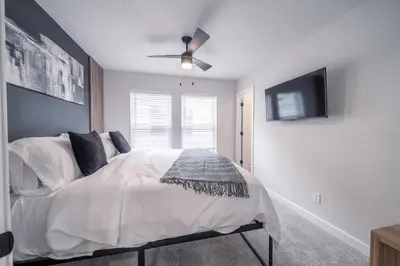 a bedroom with a bed with a ceiling fan at Arcade Game Room! Luxury New 3BR CLE Clinic UnivCircle Little Italy in Cleveland