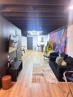 a living room with a couch and a tv at Arcade Game Room! Luxury New 3BR CLE Clinic UnivCircle Little Italy in Cleveland