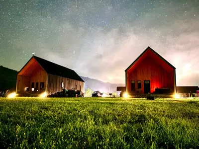 two barns in a field under a starry sky at Wildflower Walk at Three Suns Cabins in Stanton