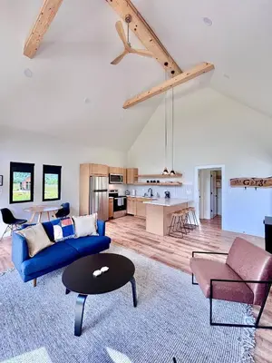 a living room with a blue couch and a table at Trail Tamer at Three Suns Cabins in Stanton
