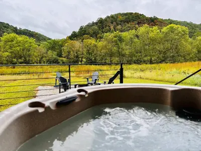 a bath tub filled with water in a field at Moonrise Meadow at Three Suns Cabins in Stanton