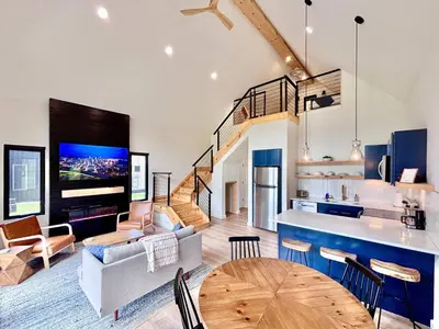 a living room with a kitchen and a dining room at Perfect Perch at Three Suns Cabins in Stanton