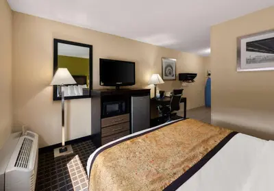 a hotel room with a bed and a flat screen tv at Best Western Adena Inn in Chillicothe