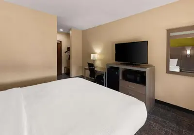 a hotel room with a bed and a flat screen tv at Best Western Adena Inn in Chillicothe