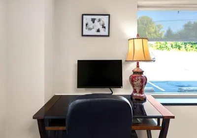 a desk with a chair and a lamp and a television at Best Western Adena Inn in Chillicothe