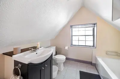 a bathroom with a sink and a toilet and a tub at Bamboo Retreat- Private Parking -New Reno -Central in Columbus