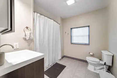 a bathroom with a toilet and a sink and a shower at Bamboo Retreat- Private Parking -New Reno -Central in Columbus